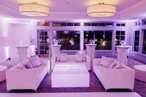 Ella's Bat Mitzvah white lounge with Ella logo pillows and glowing table