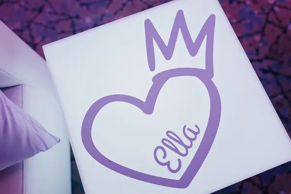Ella's Bat Mitzvah heart and crown logo on a glowing lounge cube