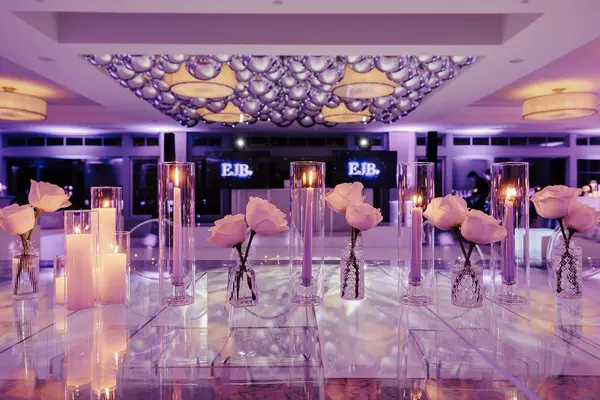 Ella's Bat Mitzvah mirrored table with roses, candles and silver balloon ceiling