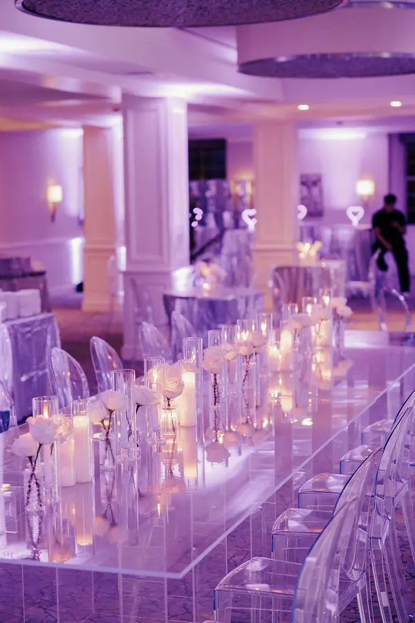 Ella's Bat Mitzvah candle and white rose runner on a mirrored table