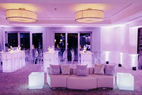 Ella's Bat Mitzvah lounge with logo pillows, glowing cubes and lit high-tops