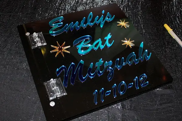 Black Lucite Sign in Book